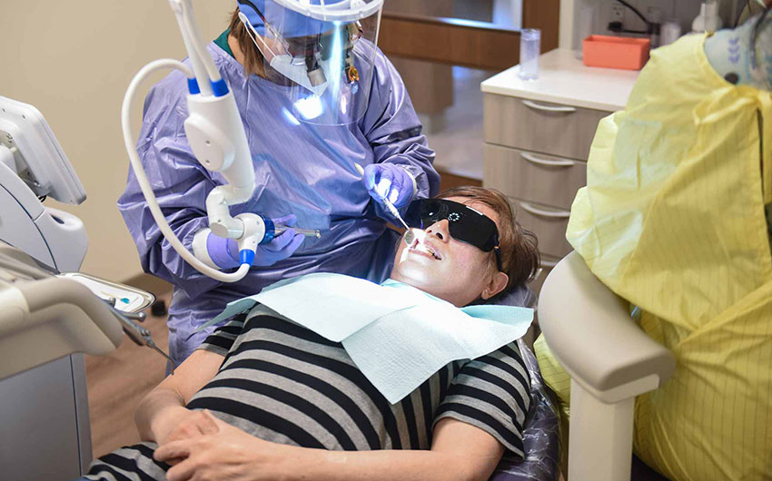 Dr. Rupenzil Gill with Patient | Solea® Laser | Dental on 8th | SE Calgary | General and Family Dentist